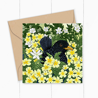 Greeting card by Fox and Boo, featuring lovely Blackbird sitting amongst primroses and wood sorrel.