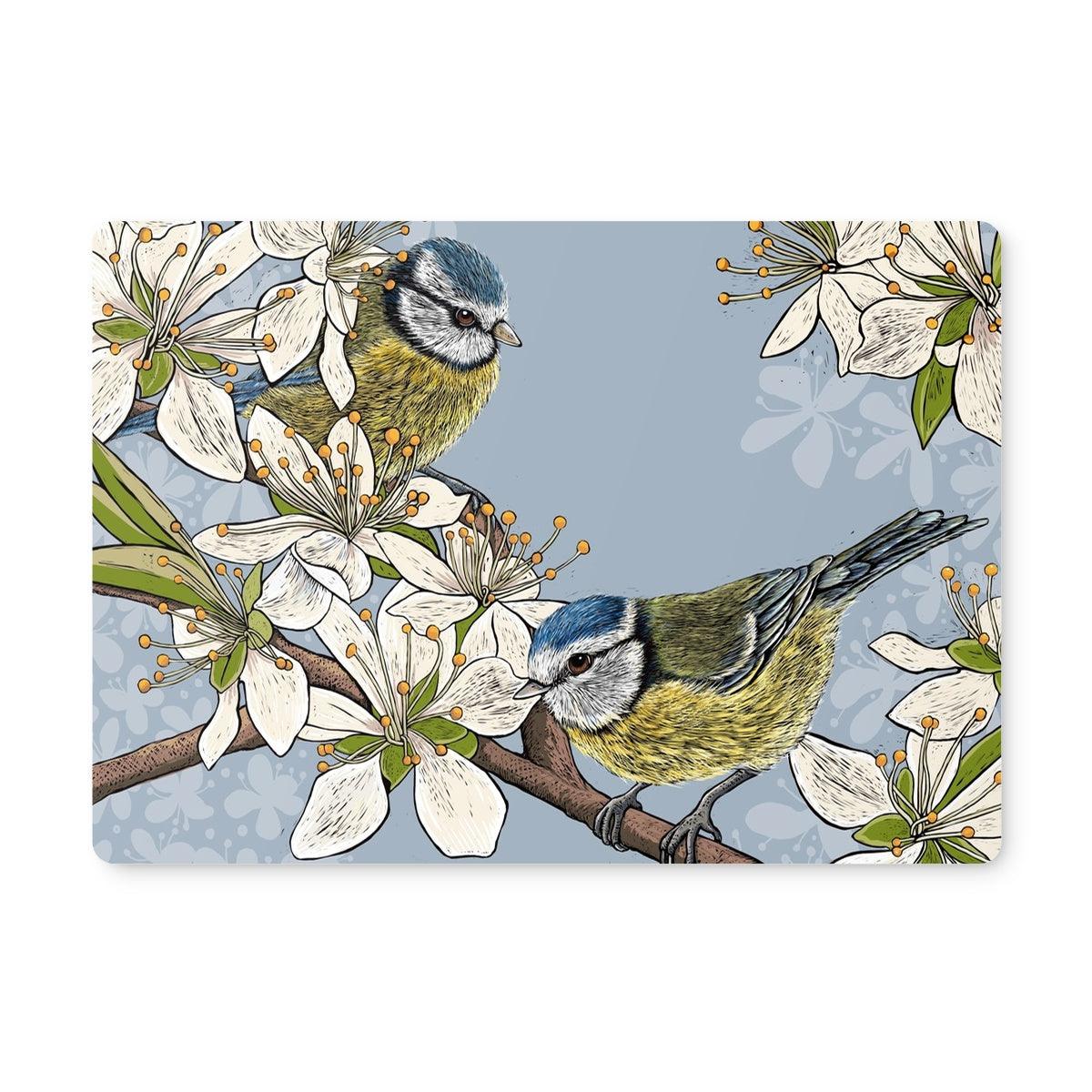 Image of placemat with two illustrated Blue Tits amongst Spring blossom, design by Fox and Boo